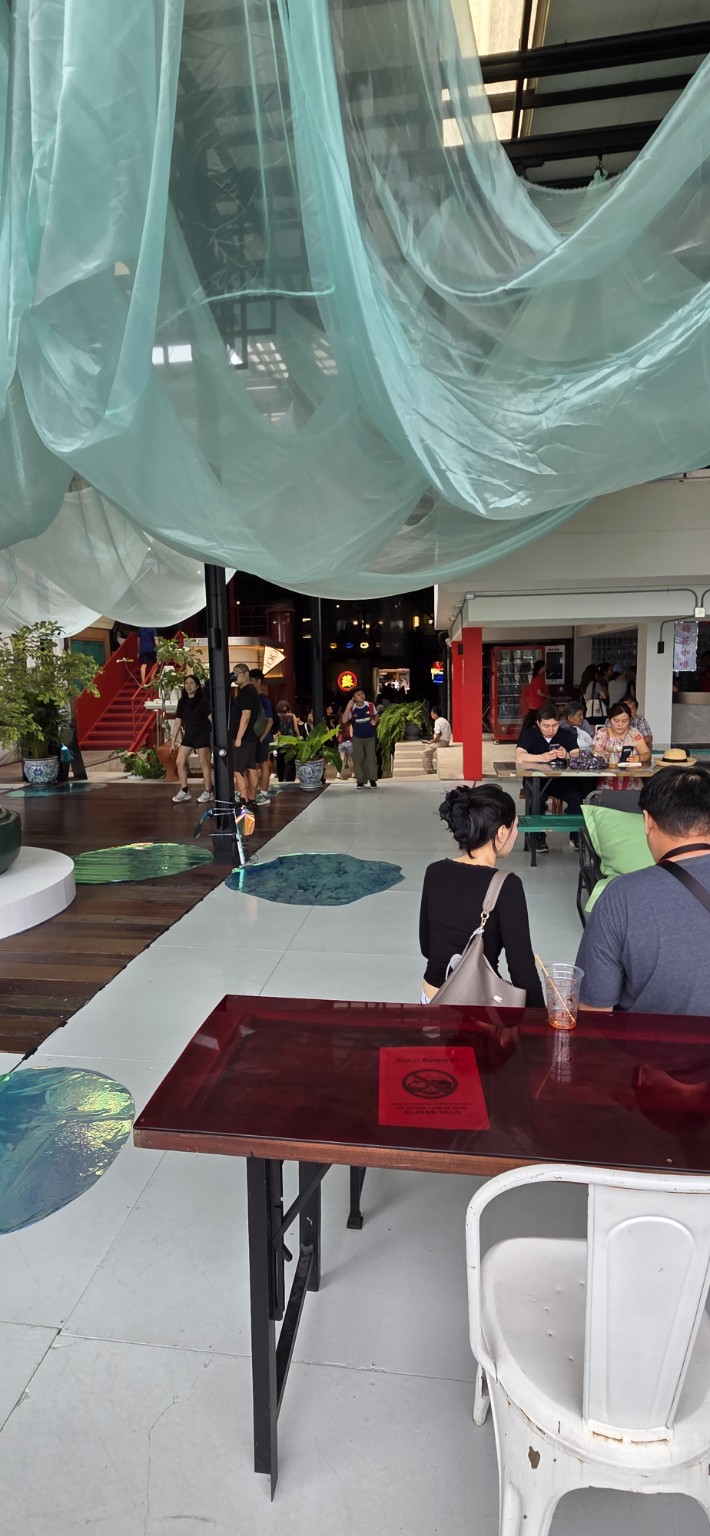 Airy Bangkok café with fabric draped overhead