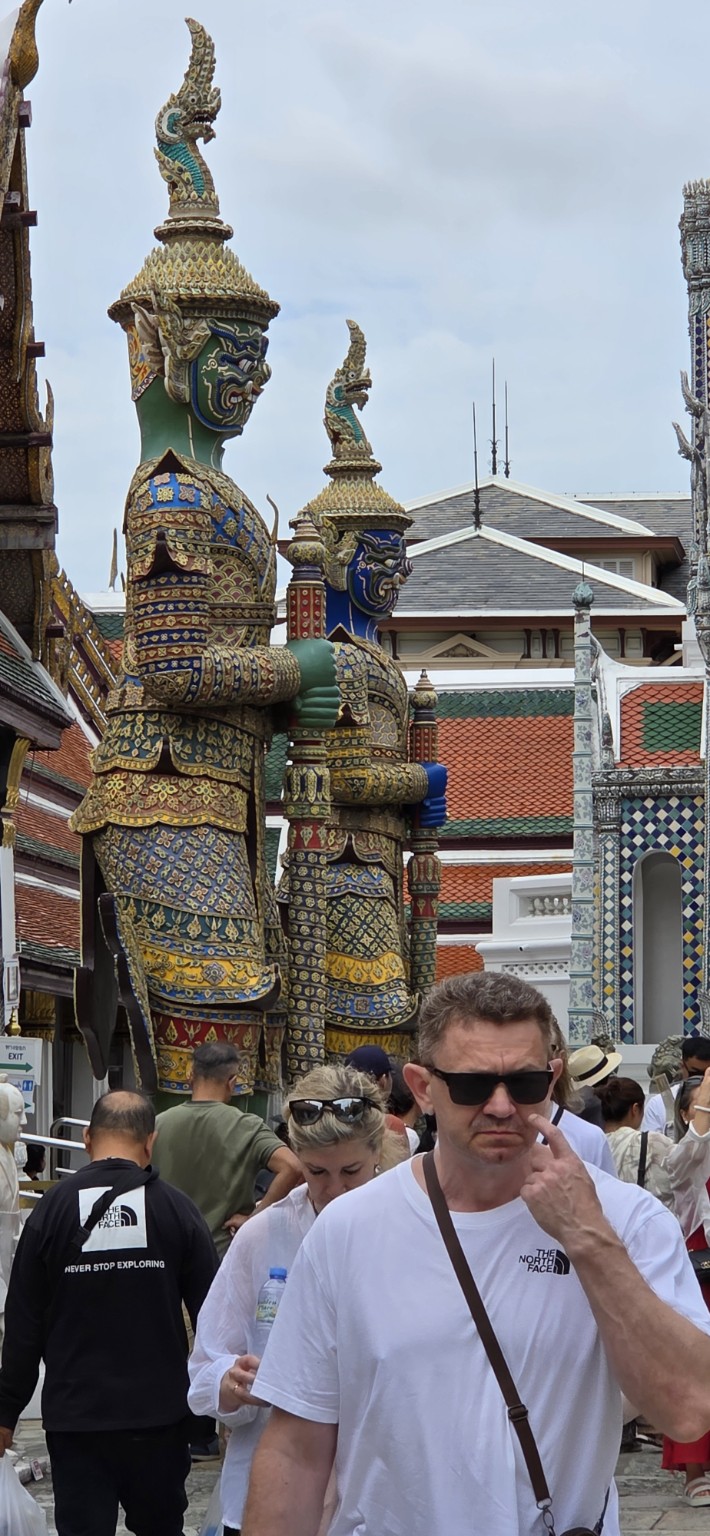 Colorful giant guardian statues standing in the Grand Palace complex