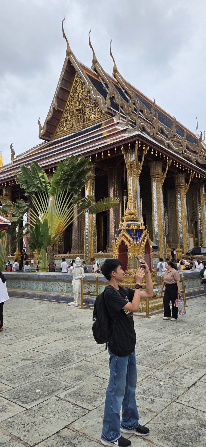 Gilded columns and layered roofs at the Grand Palace