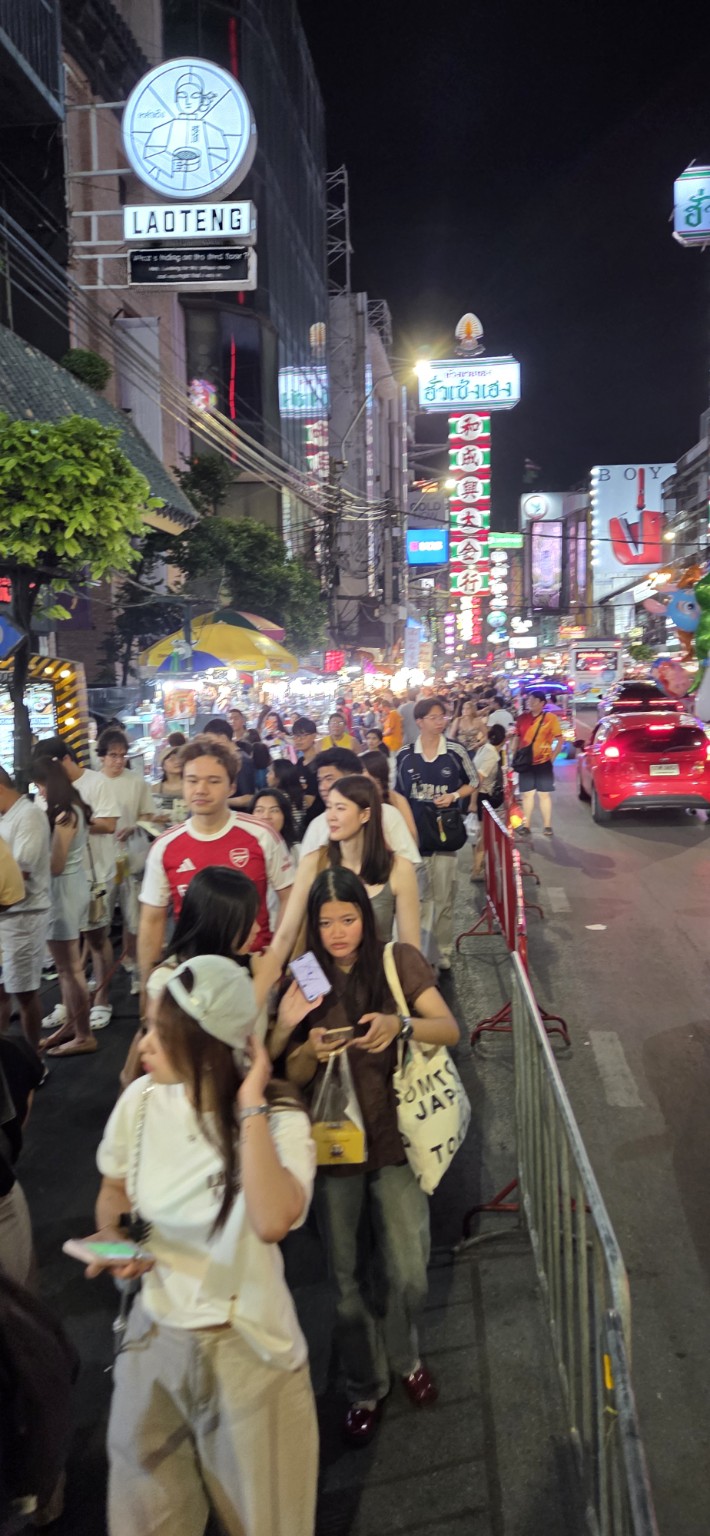 Crowds and colorful signs along Yaowarat Road at night