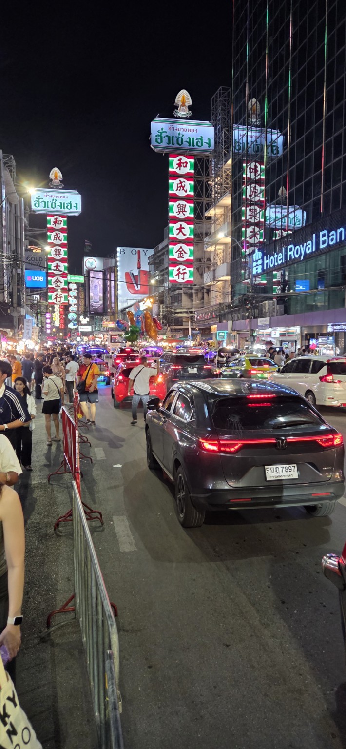 Night traffic and glowing signs filling Yaowarat Road